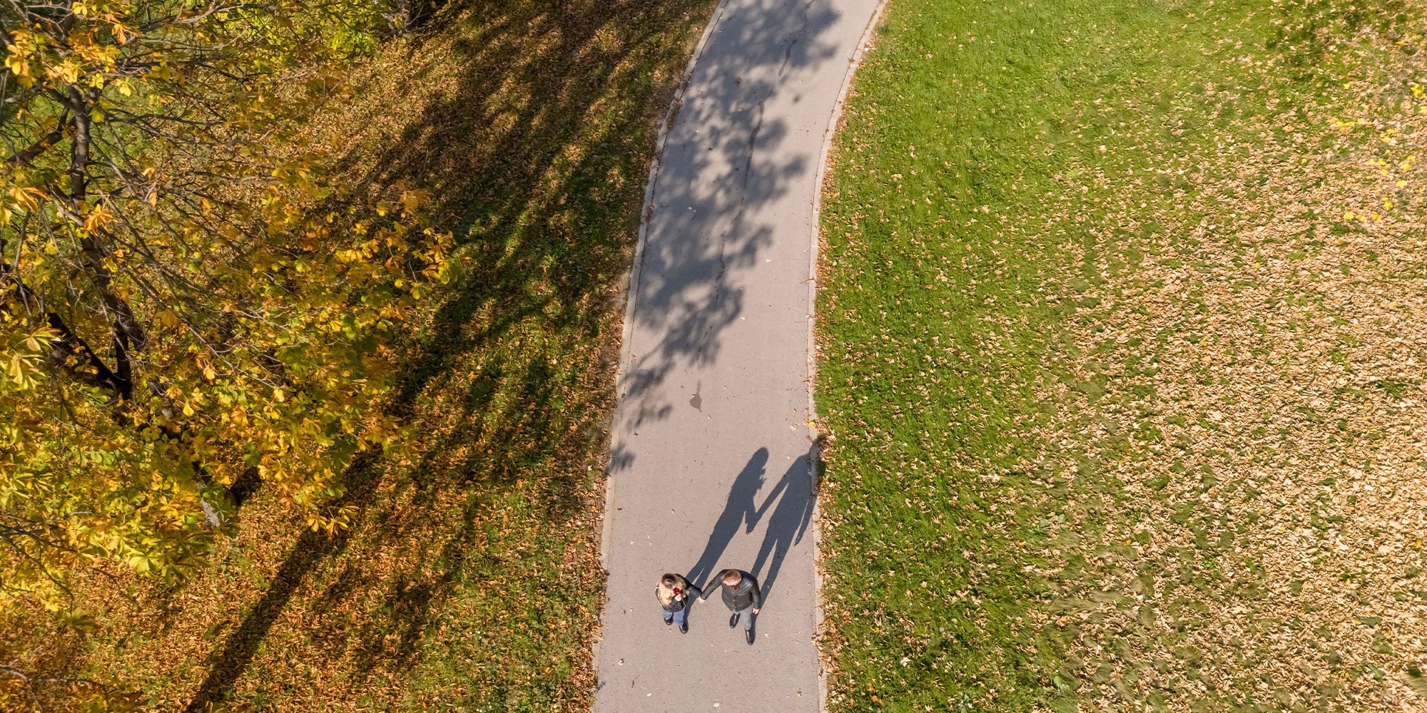 Aerial view of couple enjoying beautiful sunny day outdoors holding hands