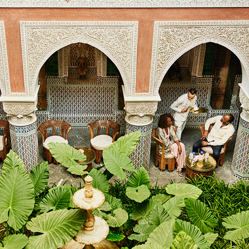 outside overlooking a patio area with intricate architectural arches and greenery