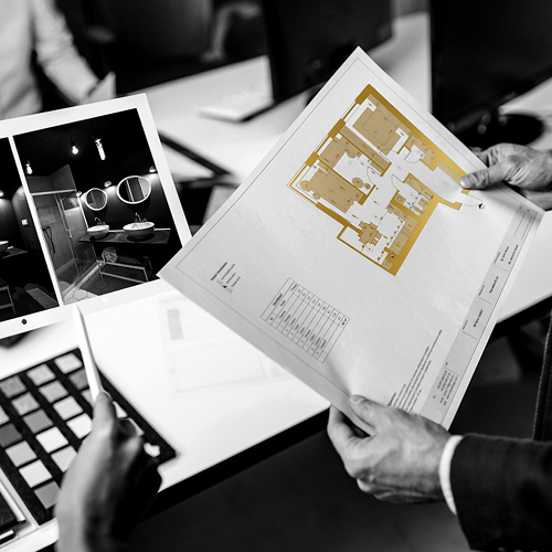 multiple hands holding architecture plans