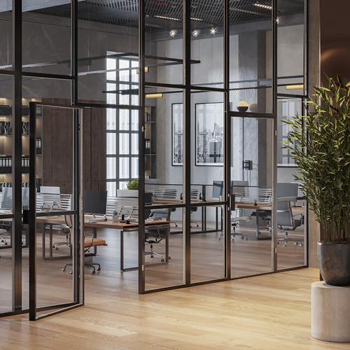 Inside of an office space with window walls and open floor plan with an open workspace