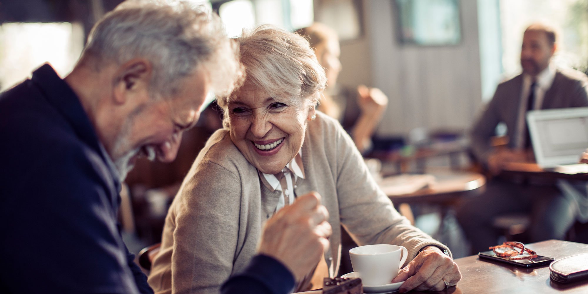 Close up of a happy senior couple having coffee in a cafe