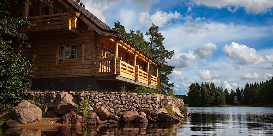 Cabin overlooking lake with blue skies