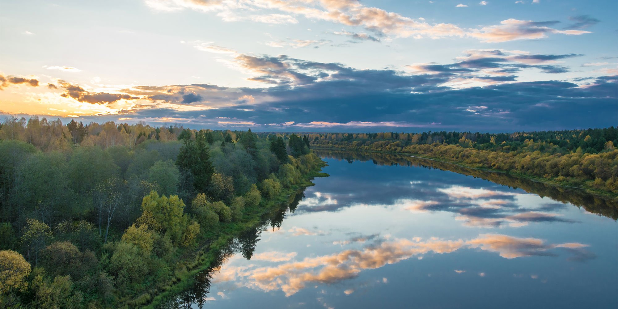 River autumn landscape in the rays of the setting sun