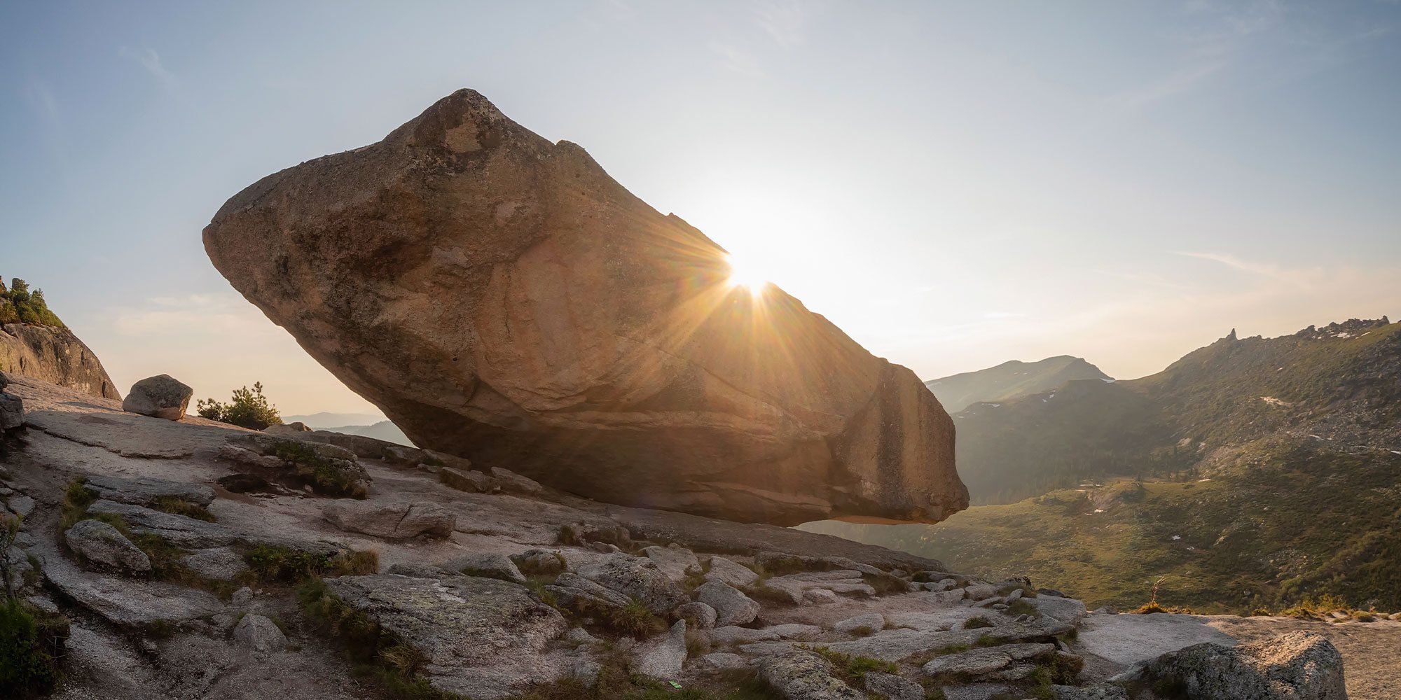 Giant balancing rock above the cliff. A natural geological phenomenon
